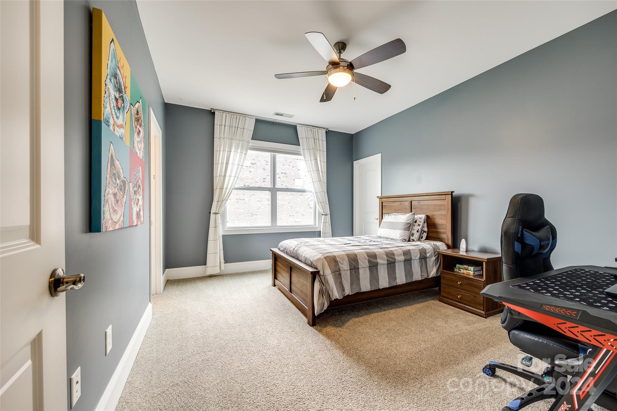 2264 Watermark Point Place Fort Mill, SC 29708 - Photo 23 of 48 a bedroom with a bed and a chandelier