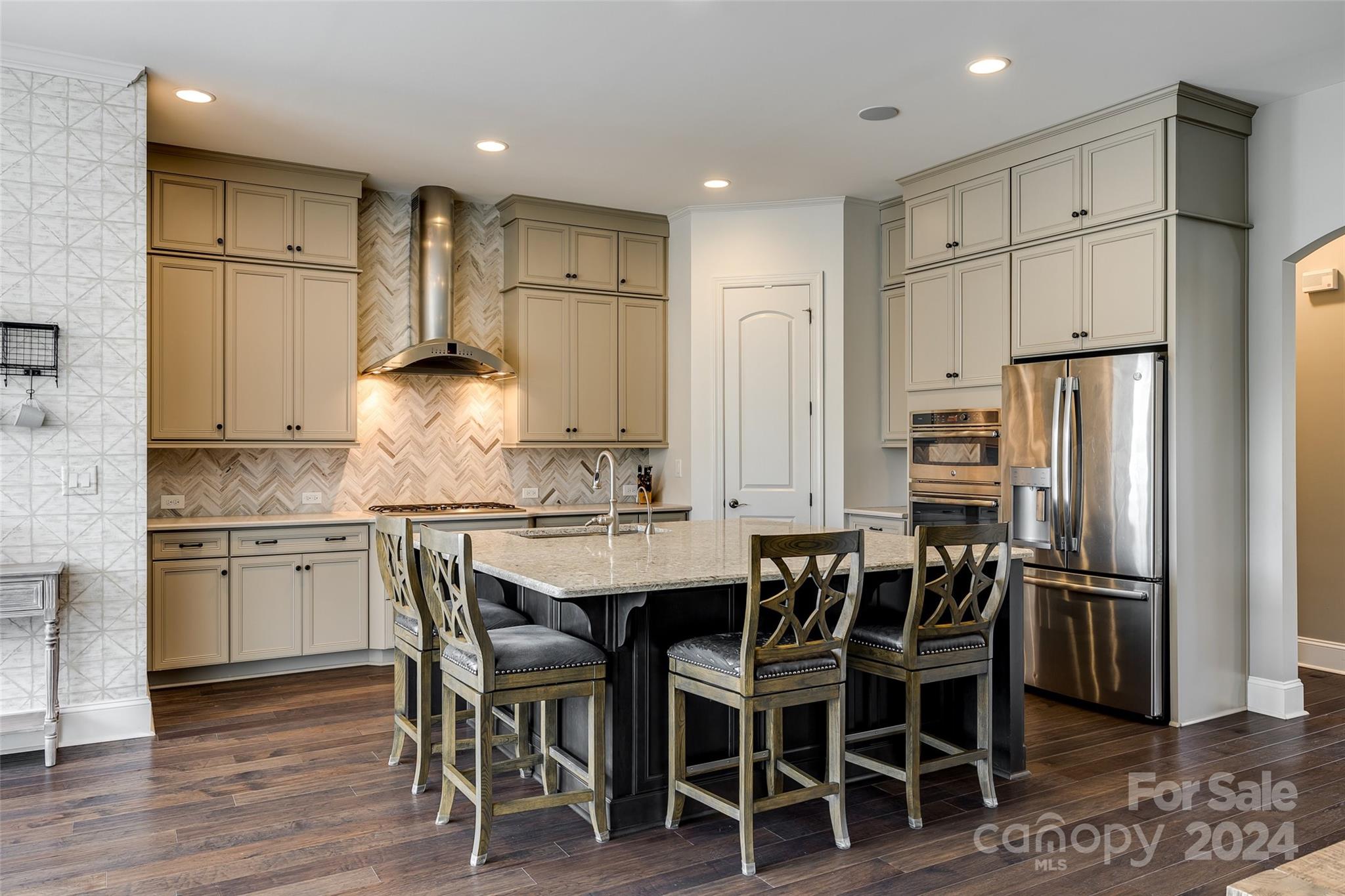 2264 Watermark Point Place Fort Mill, SC 29708 - Photo 9 of 48 a kitchen with kitchen island granite countertop stainless steel appliances a refrigerator and cabinets