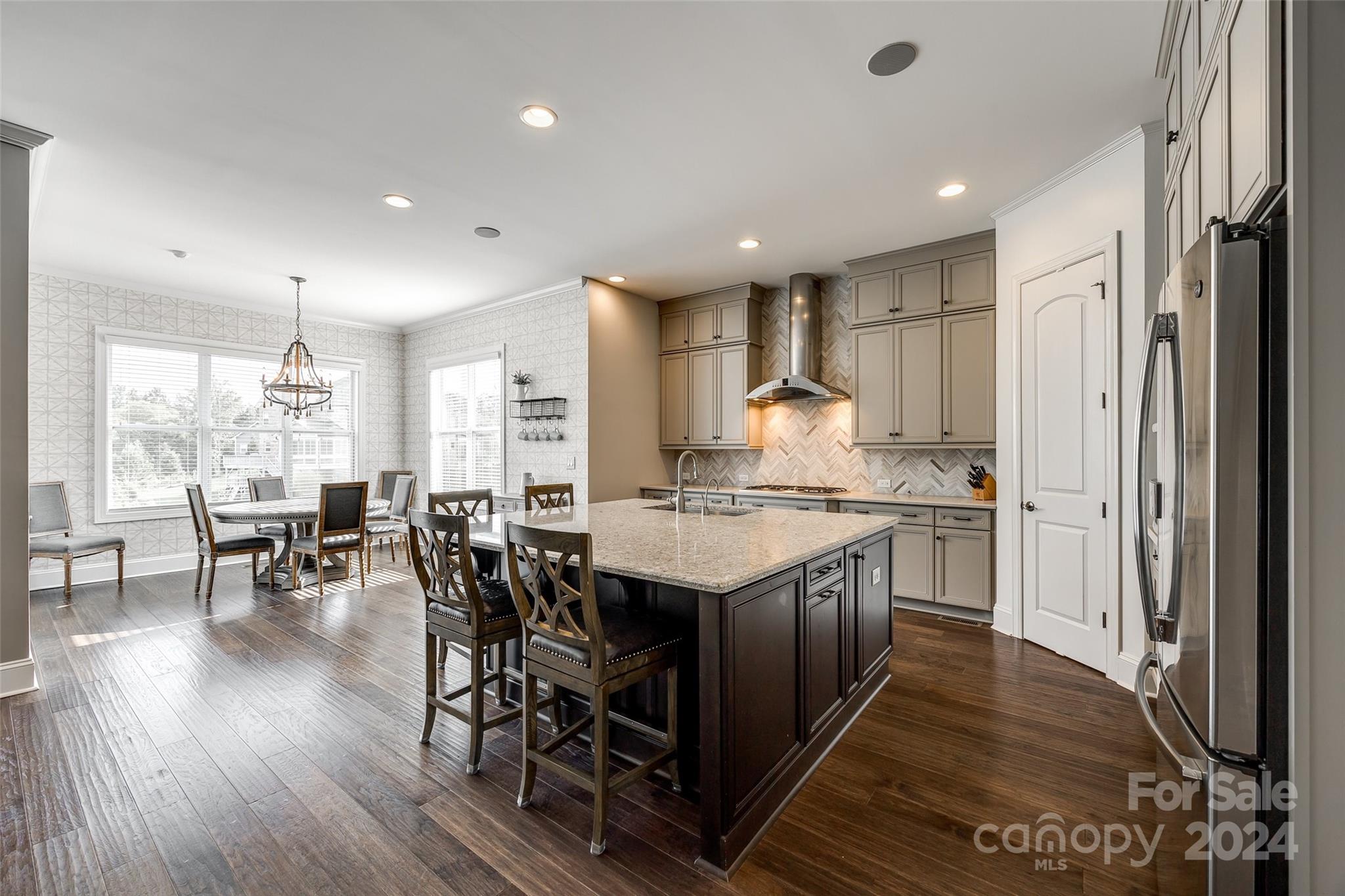2264 Watermark Point Place Fort Mill, SC 29708 - Photo 10 of 48 a kitchen with stainless steel appliances granite countertop a table chairs and a refrigerator