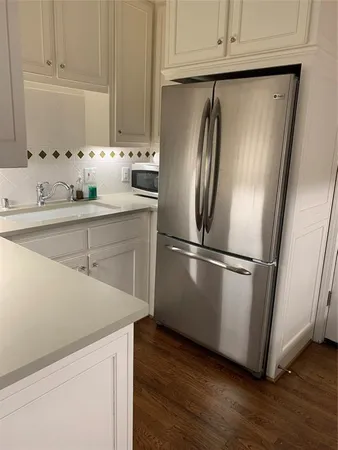 a kitchen with appliances and a refrigerator