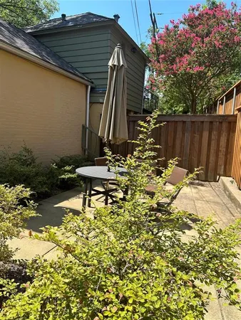 a backyard of a house with table and chairs