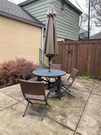 a backyard of a house with table and chairs