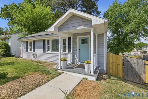 a front view of a house with outdoor seating