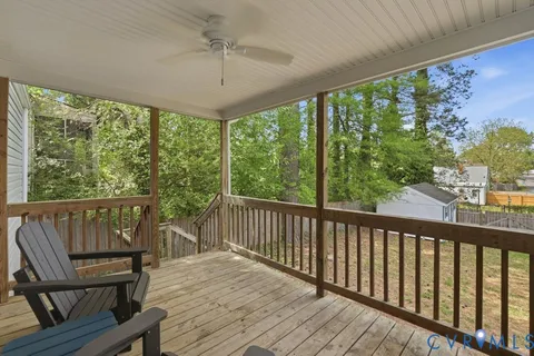 a balcony with wooden floor and outdoor seating