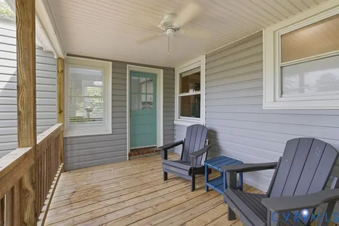 a view of backyard of house with green space