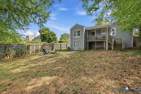 a view of a backyard with table and chairs and wooden fence