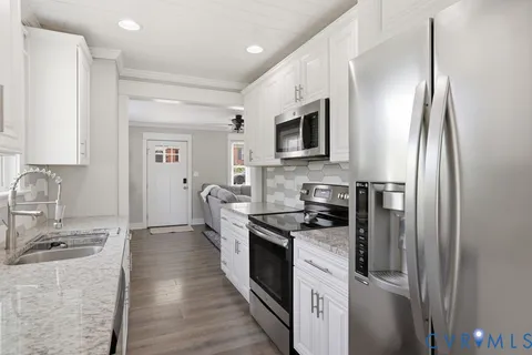 a kitchen with granite countertop a sink and a window