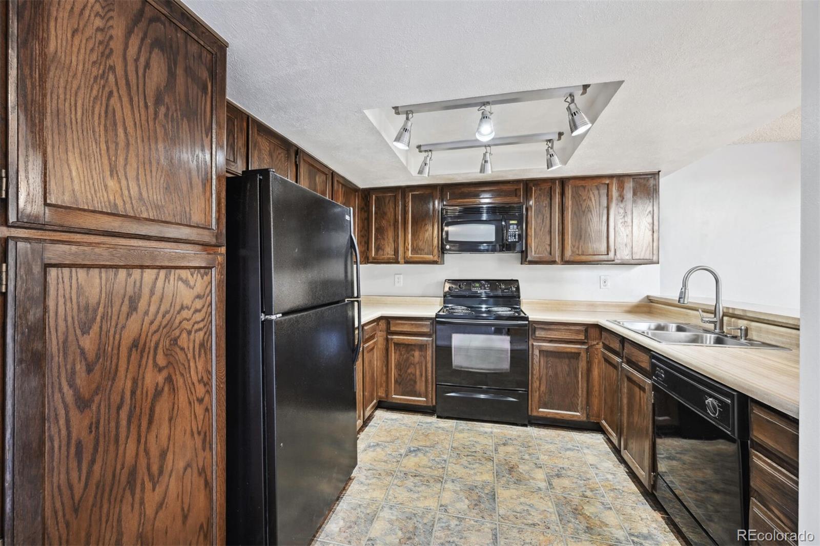 72 South Holman Way Golden, CO 80401 - Photo 13 of 34 a kitchen with stainless steel appliances granite countertop a refrigerator sink and stove