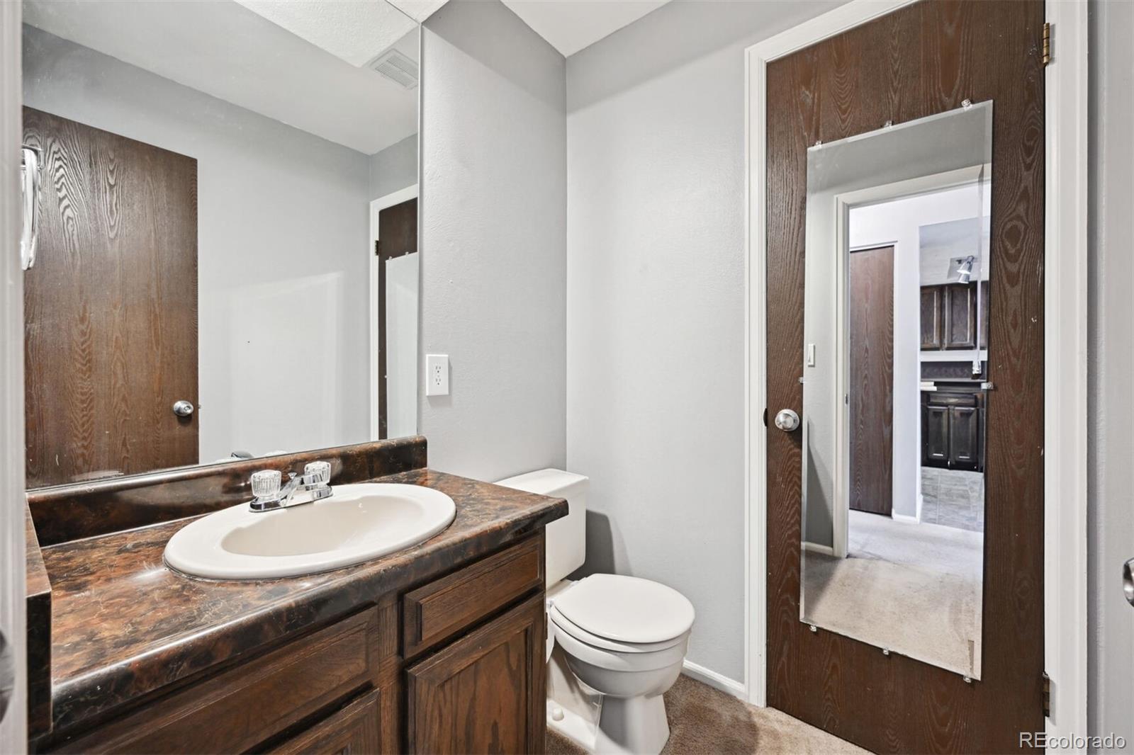 72 South Holman Way Golden, CO 80401 - Photo 17 of 34 a bathroom with a granite countertop sink toilet and shower