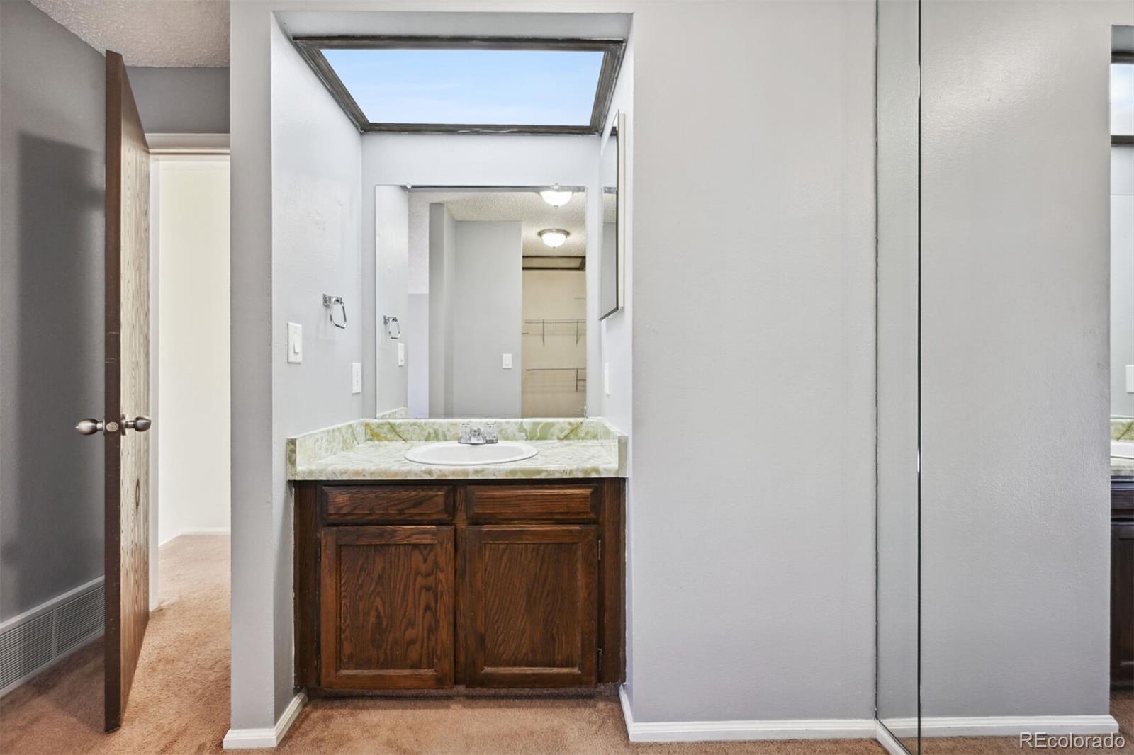 72 South Holman Way Golden, CO 80401 - Photo 21 of 34 a view of hallway with a sink and mirror