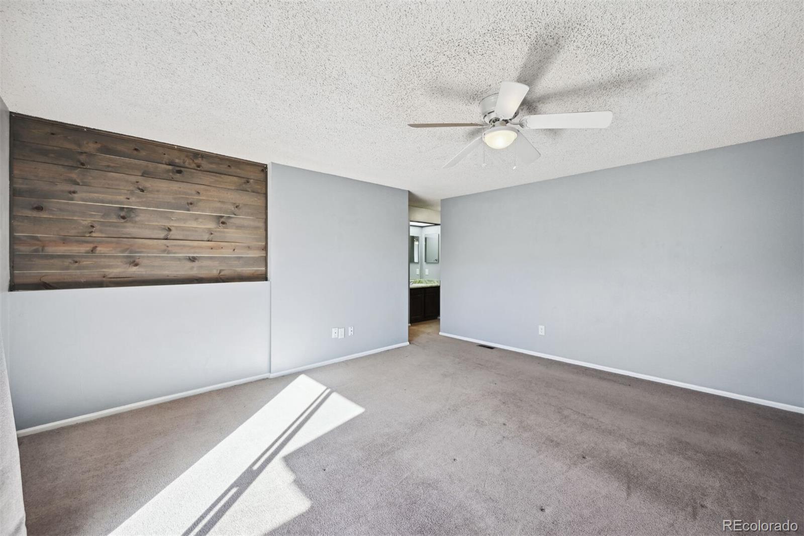72 South Holman Way Golden, CO 80401 - Photo 22 of 34 an empty room with a ceiling fan and a window