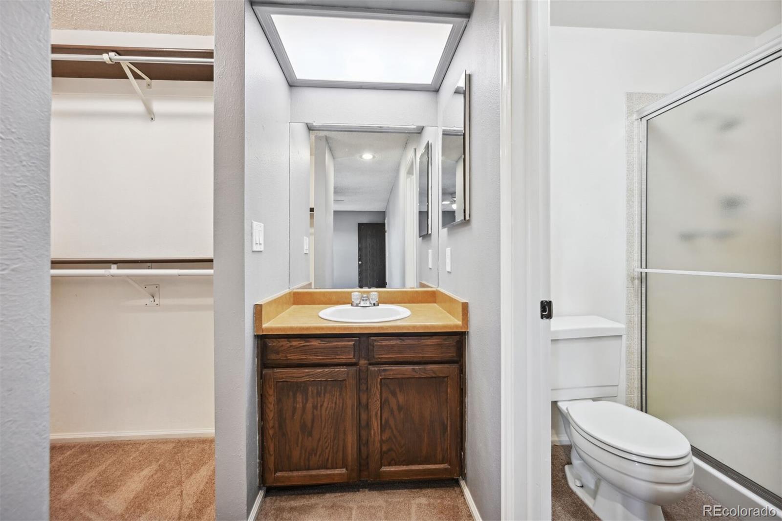 72 South Holman Way Golden, CO 80401 - Photo 24 of 34 a bathroom with a granite countertop sink toilet and shower