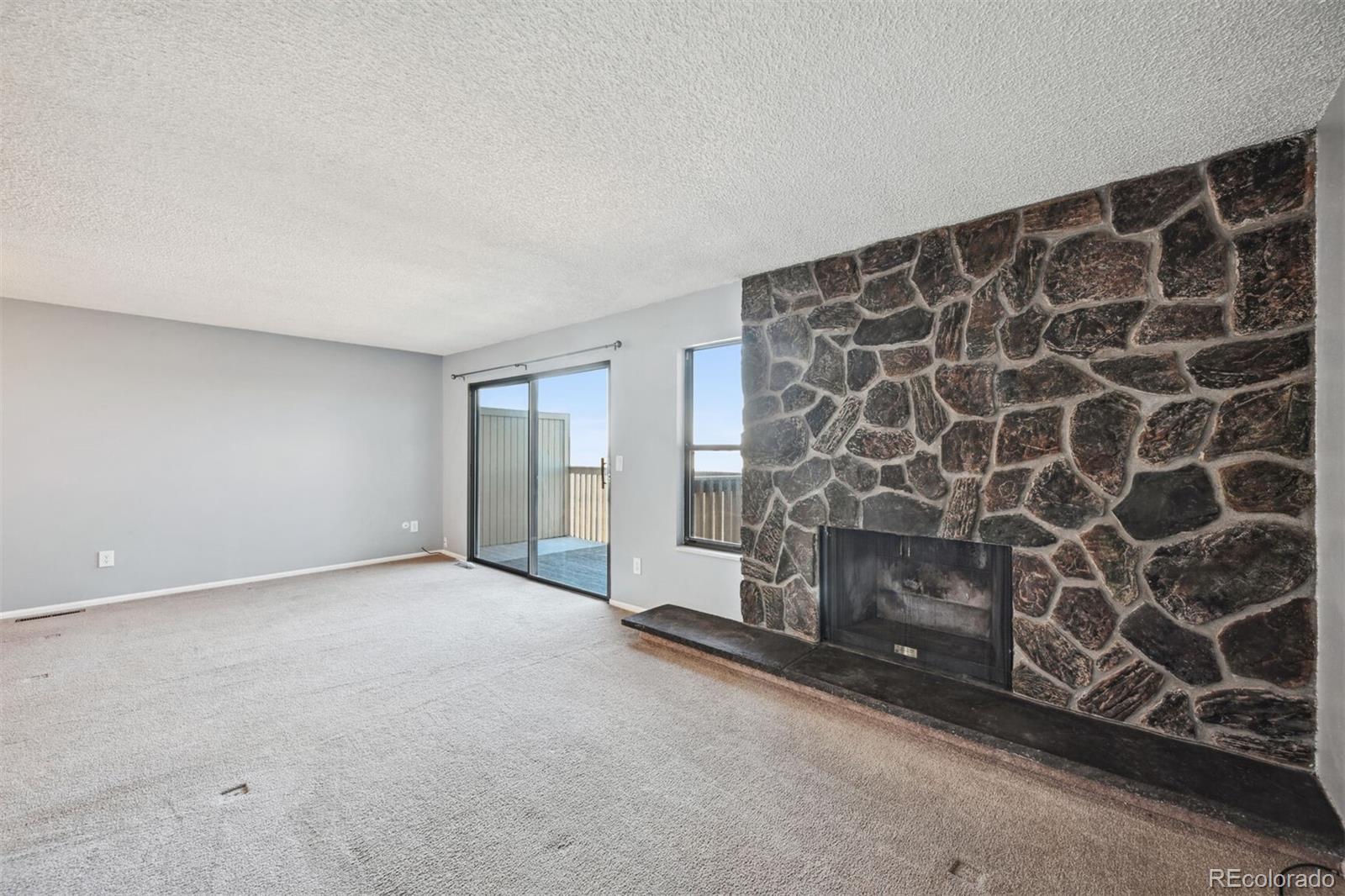 72 South Holman Way Golden, CO 80401 - Photo 6 of 34 a view of an empty room with a fireplace