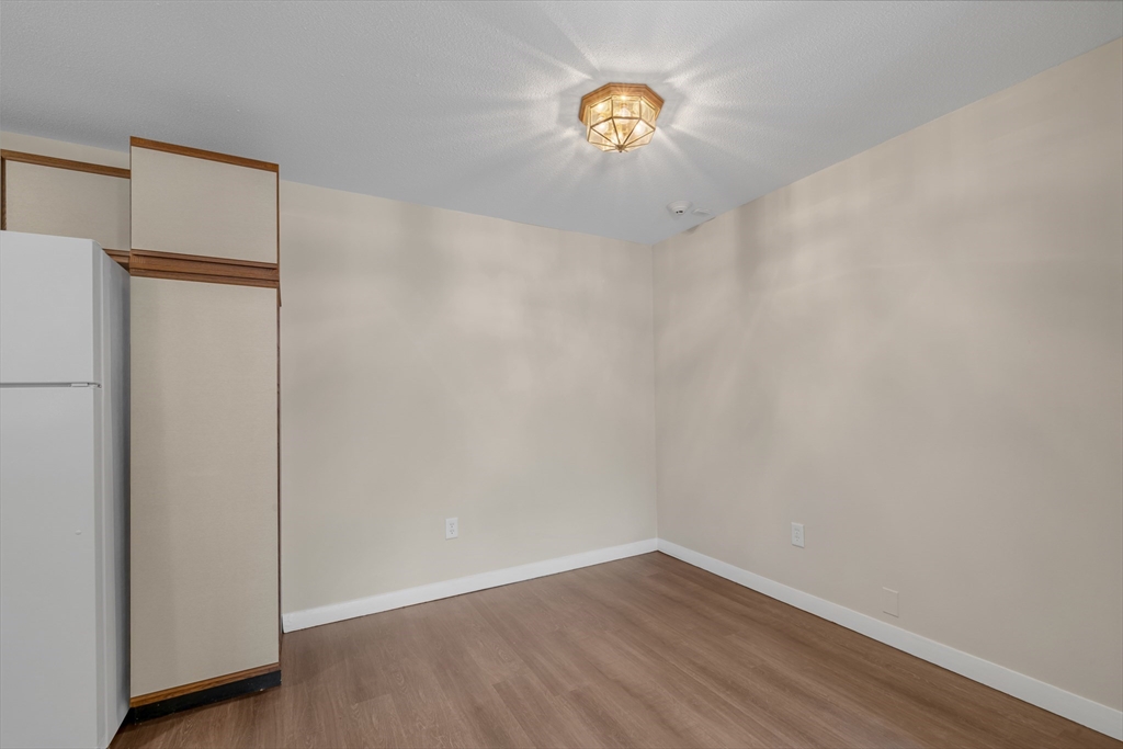 74 Beach Street, Unit 11 Woburn, MA 01801 - Photo 17 of 34 a view of a storage & utility room with wooden floor