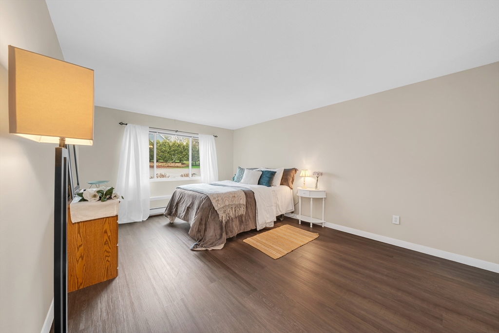 74 Beach Street, Unit 11 Woburn, MA 01801 - Photo 19 of 34 a bedroom with a bed and wooden floor
