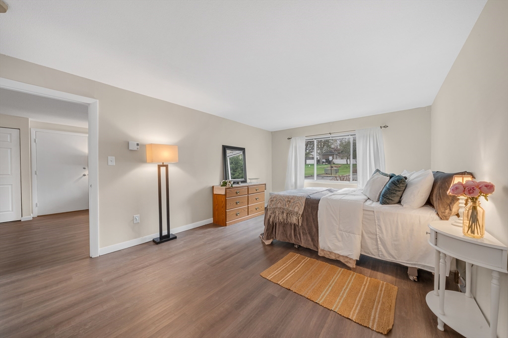 74 Beach Street, Unit 11 Woburn, MA 01801 - Photo 20 of 34 a spacious bedroom with a bed and wooden floor