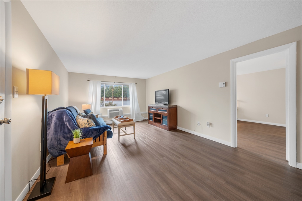 74 Beach Street, Unit 11 Woburn, MA 01801 - Photo 2 of 34 a living room with furniture and a wooden floor
