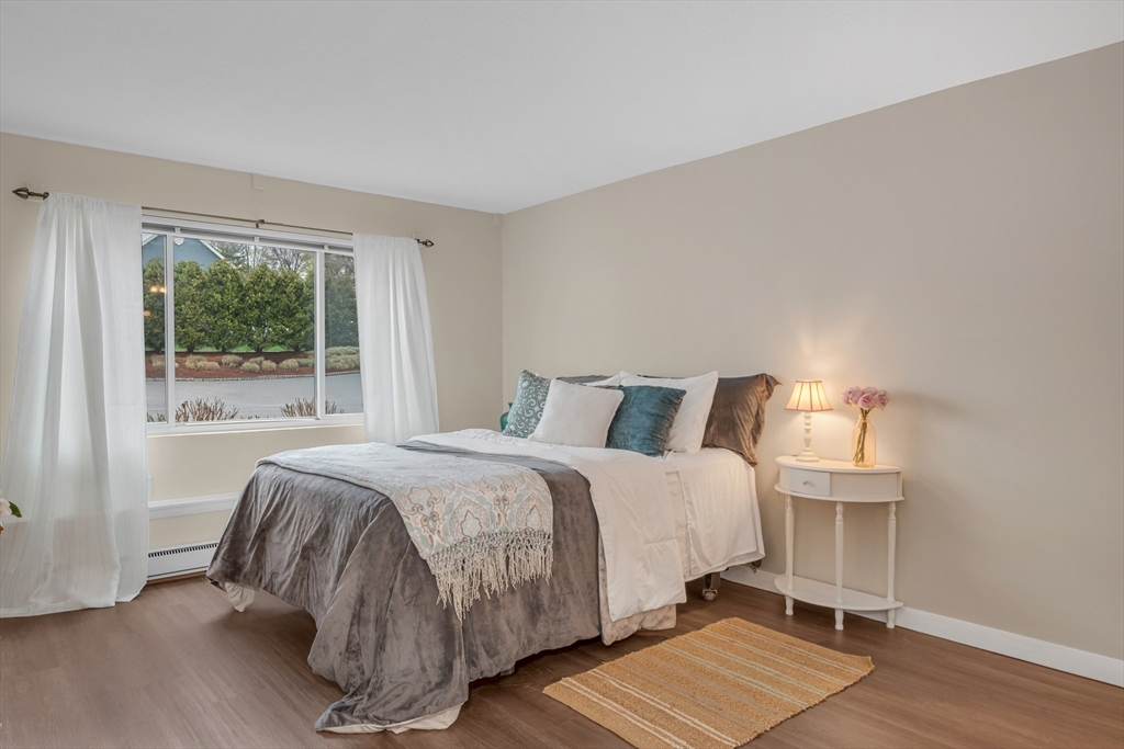 74 Beach Street, Unit 11 Woburn, MA 01801 - Photo 21 of 34 a bedroom with a bed and wooden floor