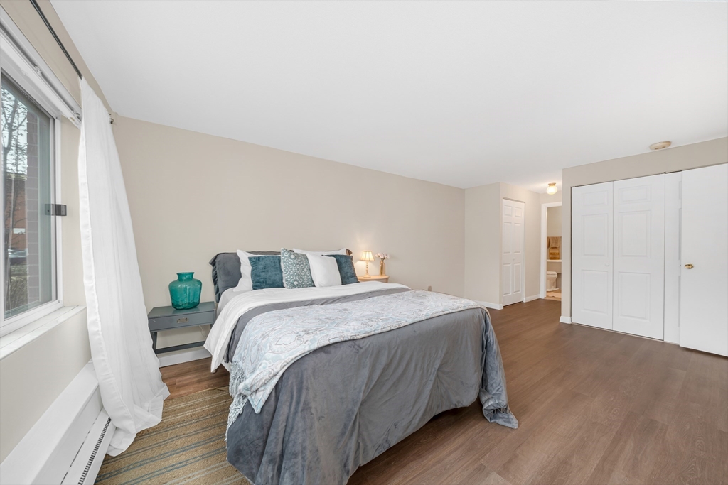 74 Beach Street, Unit 11 Woburn, MA 01801 - Photo 22 of 34 a bedroom with a bed and wooden floor