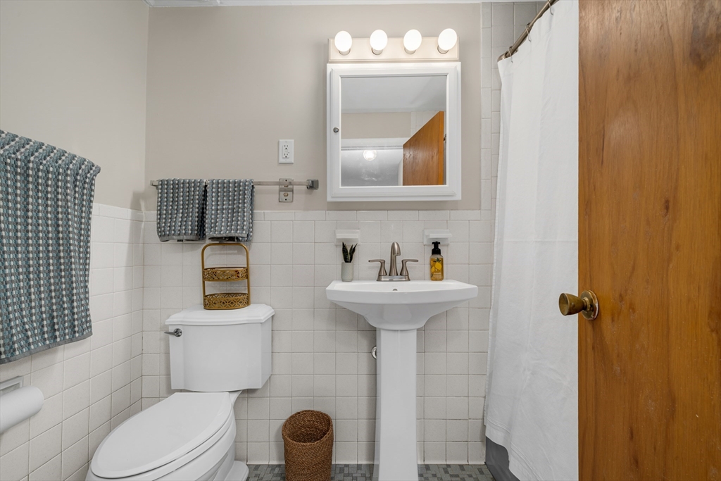 74 Beach Street, Unit 11 Woburn, MA 01801 - Photo 25 of 34 a bathroom with a sink toilet and mirror