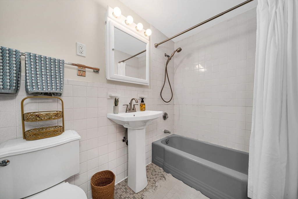 74 Beach Street, Unit 11 Woburn, MA 01801 - Photo 26 of 34 a bathroom with a sink a toilet and shower