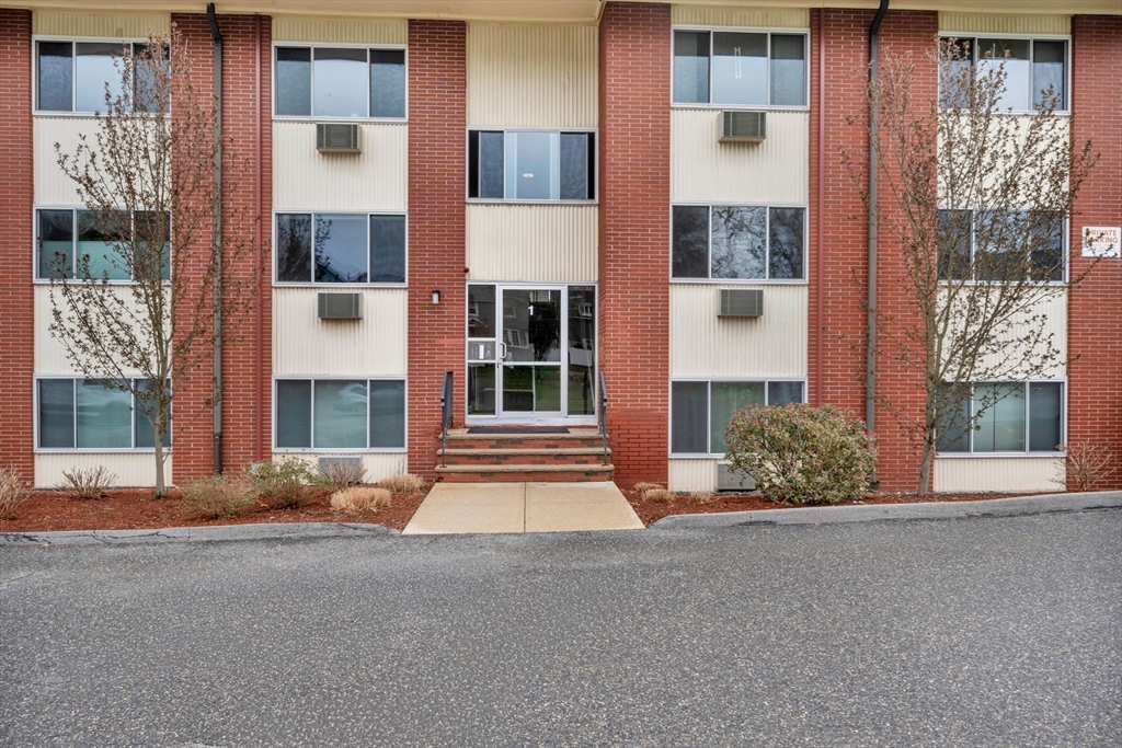 74 Beach Street, Unit 11 Woburn, MA 01801 - Photo 29 of 34 a front view of a building with a garden