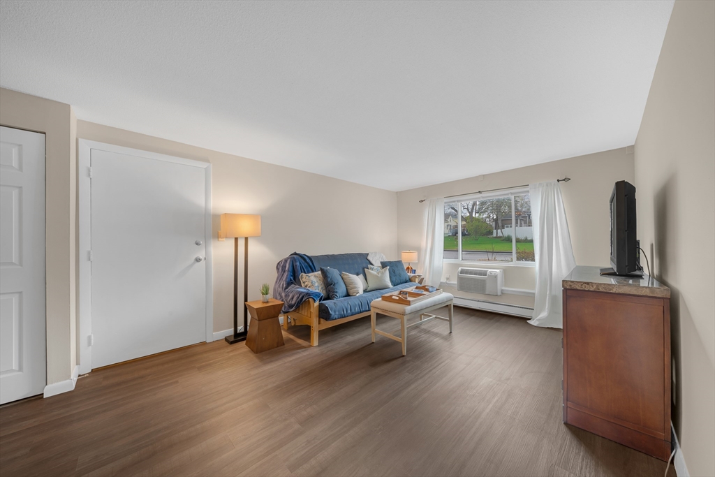 74 Beach Street, Unit 11 Woburn, MA 01801 - Photo 3 of 34 a living room with furniture and a wooden floor