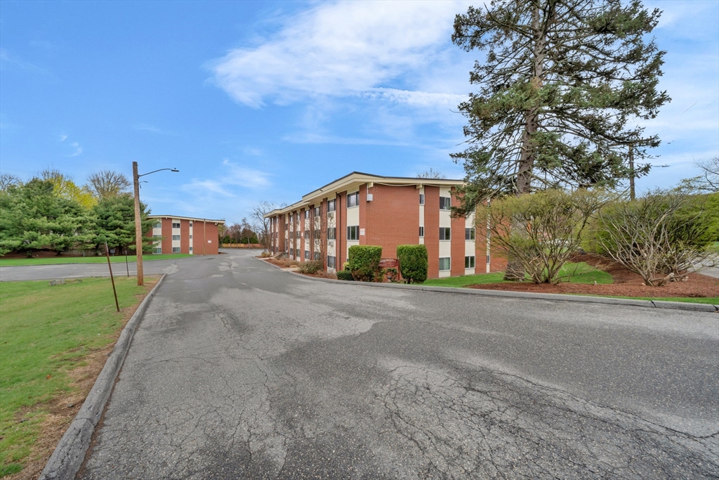 74 Beach Street, Unit 11 Woburn, MA 01801 - Photo 31 of 34 a city view with tall buildings and a yard in front of it