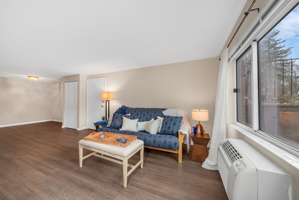 74 Beach Street, Unit 11 Woburn, MA 01801 - Photo 4 of 34 a bedroom with furniture and a large window