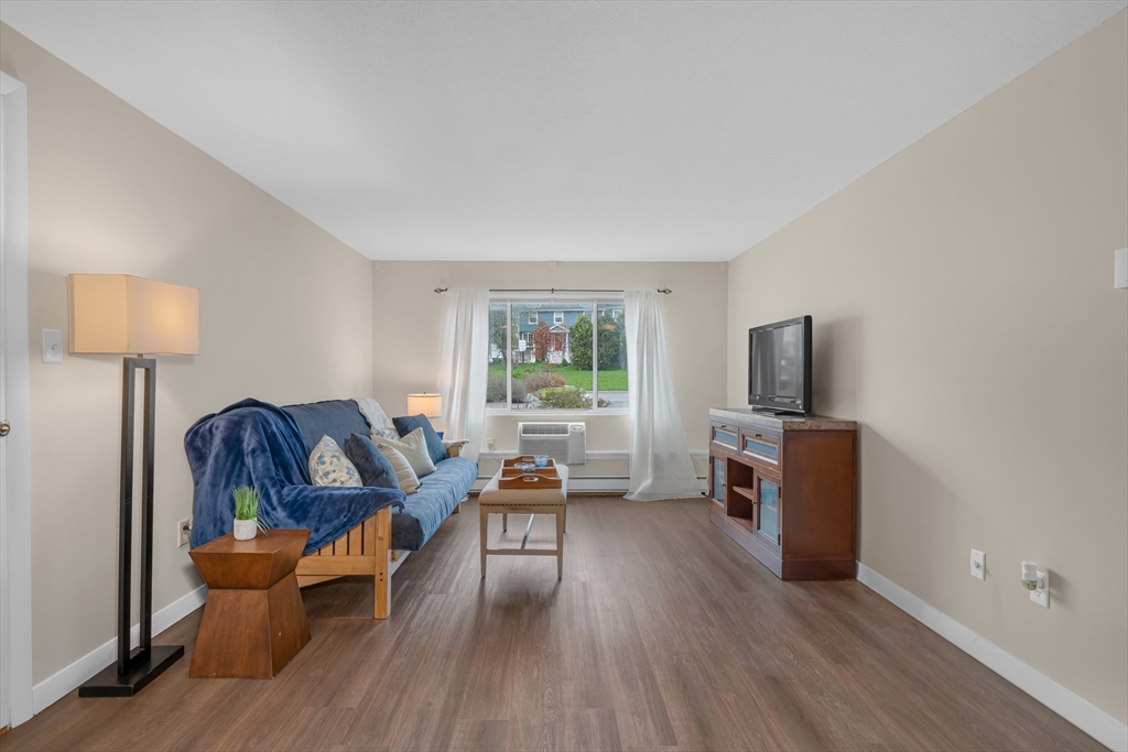 74 Beach Street, Unit 11 Woburn, MA 01801 - Photo 6 of 34 a living room with furniture and a flat screen tv