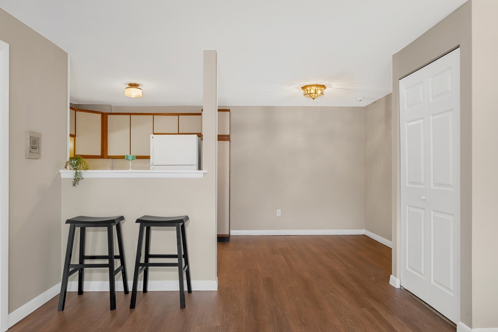 74 Beach Street, Unit 11 Woburn, MA 01801 - Photo 9 of 34 a view of a hallway with wooden floor and furniture