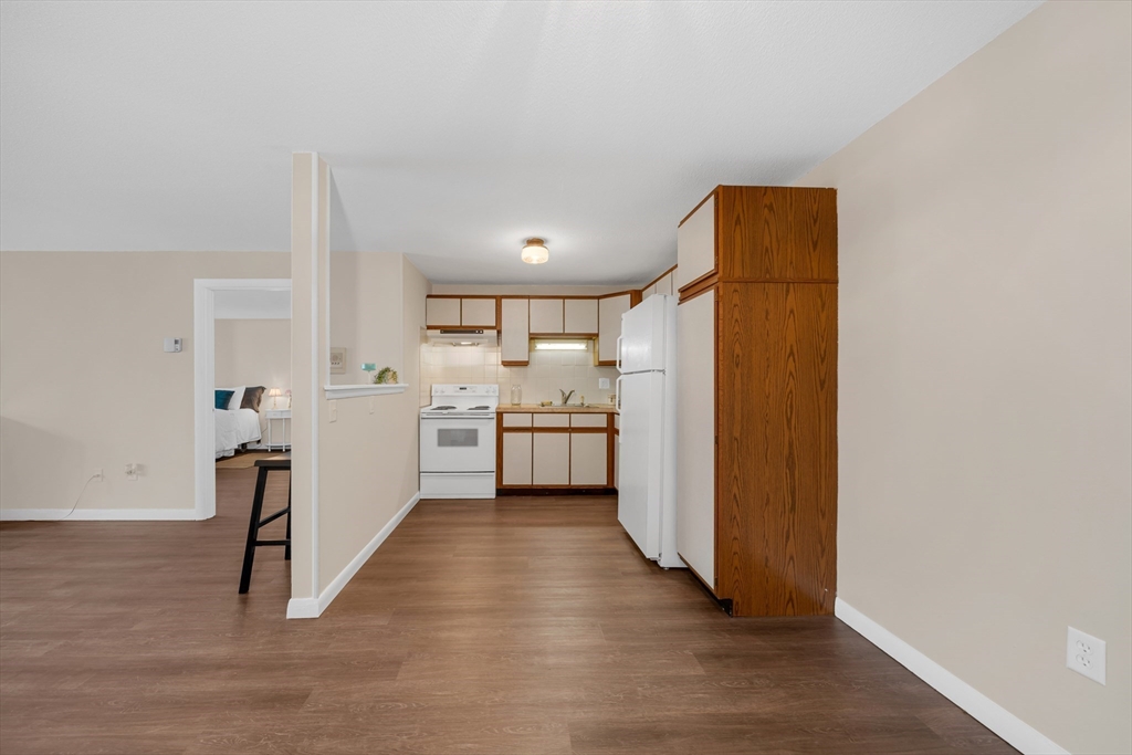 74 Beach Street, Unit 11 Woburn, MA 01801 - Photo 10 of 34 a view of a kitchen with a sink and dishwasher with wooden floor