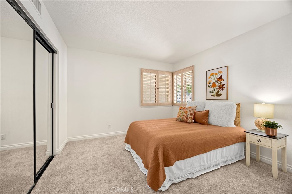 2959 Bluebell Avenue Brea, CA 92821 - Photo 15 of 22 a bedroom with a large bed and a chandelier