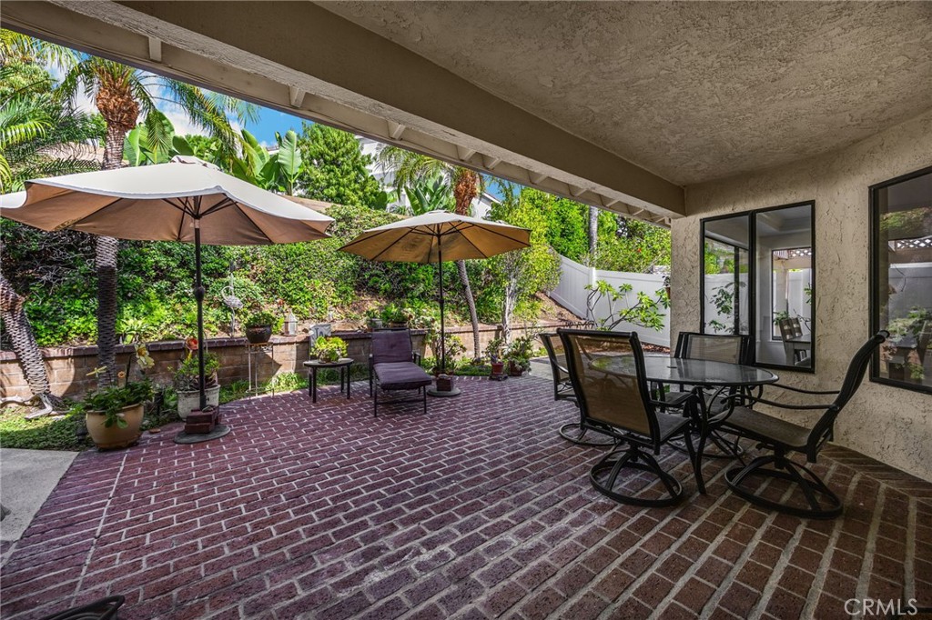 2959 Bluebell Avenue Brea, CA 92821 - Photo 18 of 22 a view of a patio with table and chairs under an umbrella with a barbeque