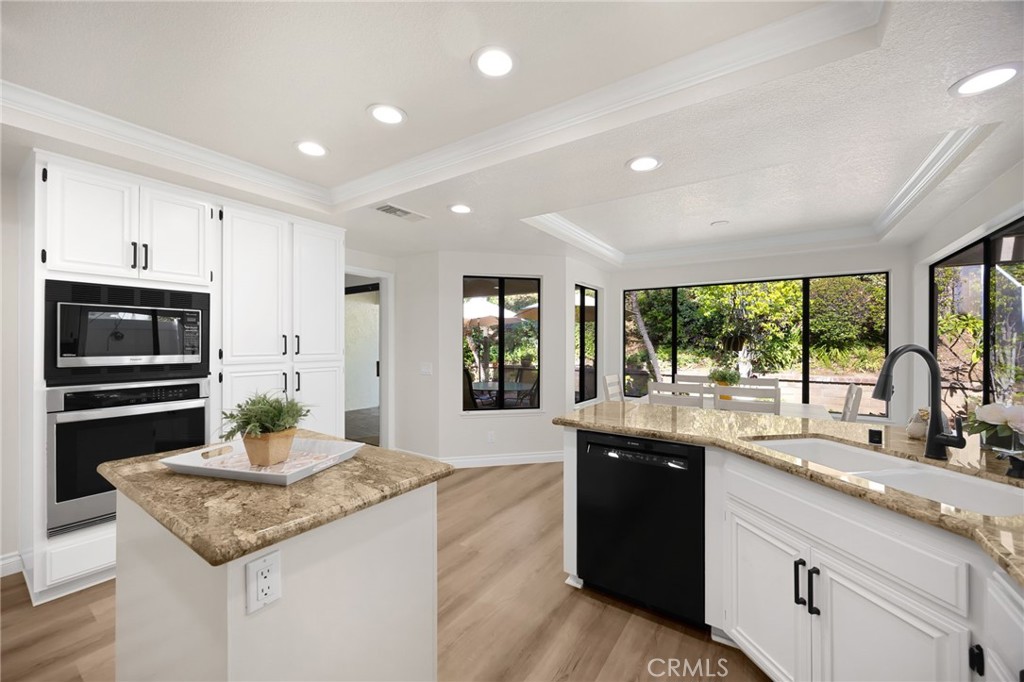 2959 Bluebell Avenue Brea, CA 92821 - Photo 5 of 22 a kitchen with stainless steel appliances granite countertop a sink and dishwasher a oven with wooden cabinets