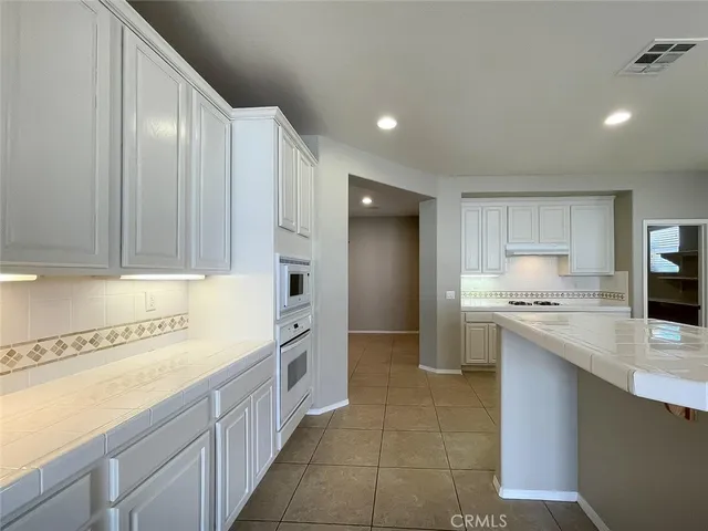 a kitchen with stainless steel appliances granite countertop a sink and cabinets