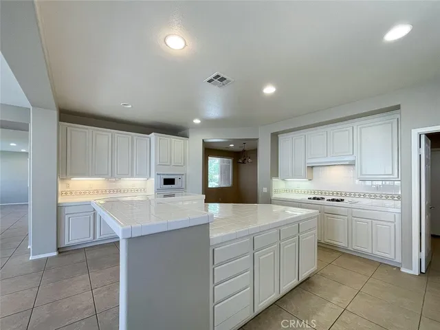 a kitchen with a sink window and cabinets