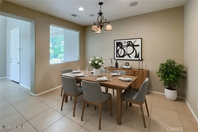 a view of a dining room with furniture and a potted plant