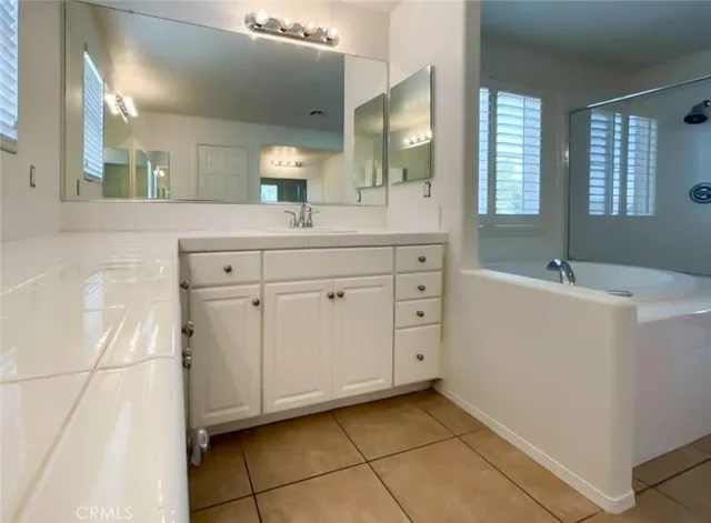 a spacious bathroom with a double vanity sink mirror and
