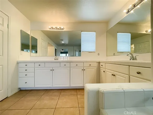 a bathroom with a sink a large mirror and a bathtub