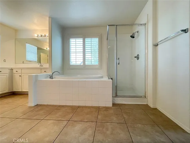 a bathroom with a tub a sink and a shower