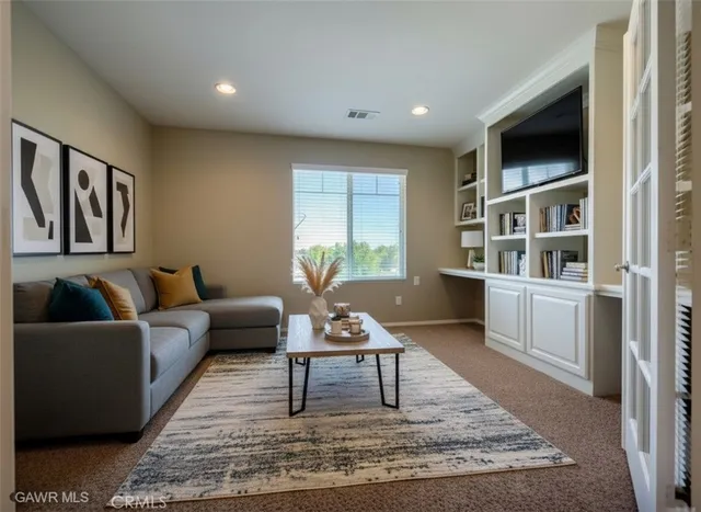 a living room with furniture and a rug