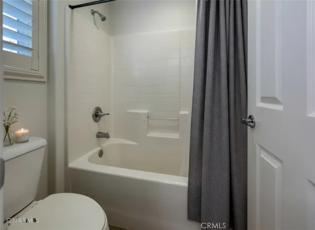 a white bath tub sitting next to a white toilet