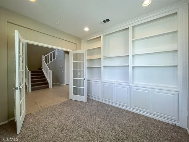 a view of an empty room with empty shelves