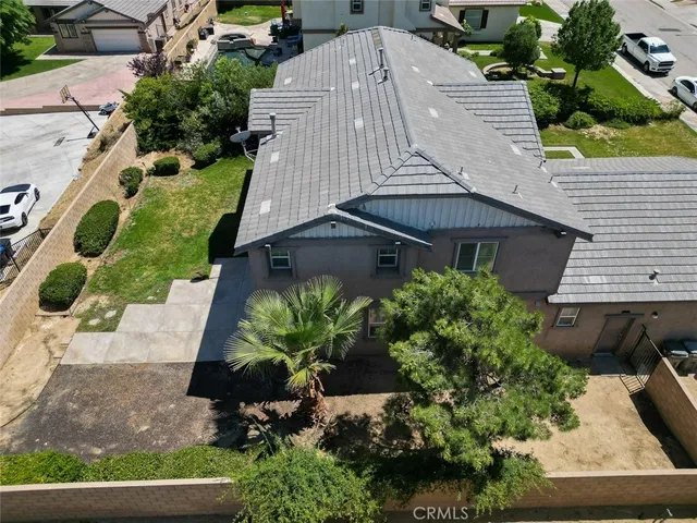 an aerial view of a house with a yard