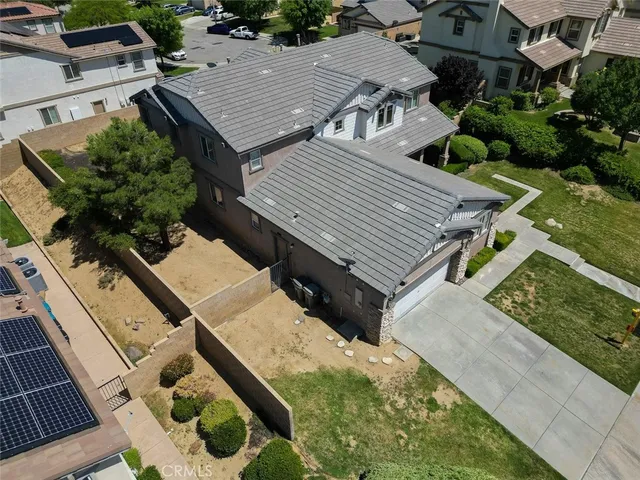 a front view of a house with a garden and yard