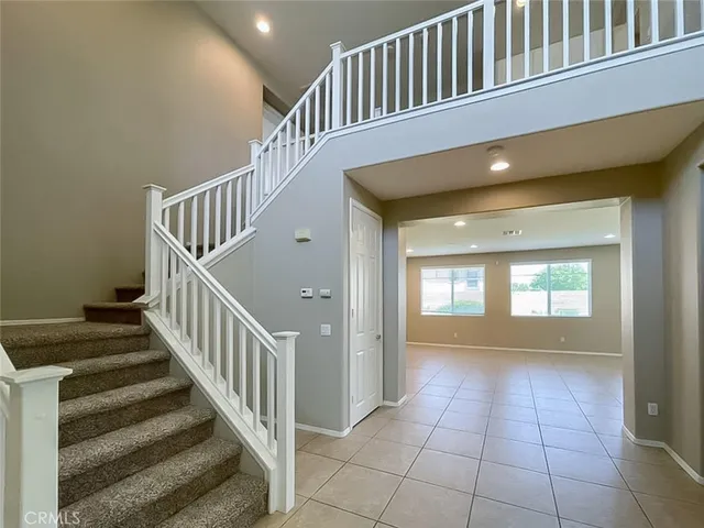 a view of an entryway and livingroom with stairs