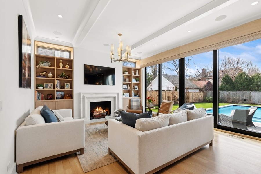 240 Raleigh Road Kenilworth, IL 60043 - Photo 15 of 71 a living room with furniture fireplace and a large window