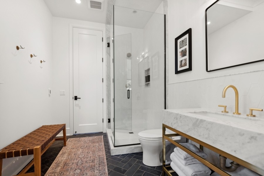 240 Raleigh Road Kenilworth, IL 60043 - Photo 31 of 71 a bathroom with a granite countertop sink toilet and shower