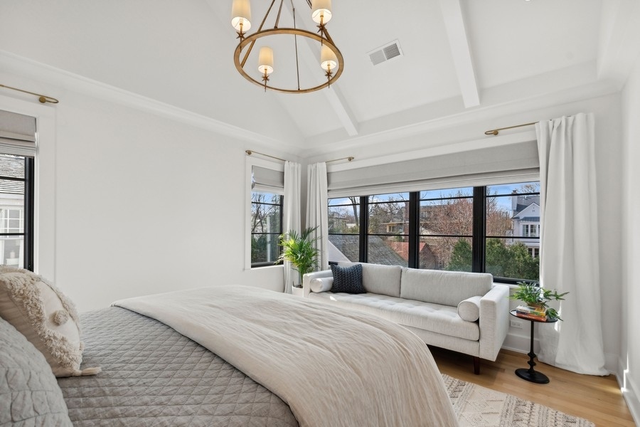 240 Raleigh Road Kenilworth, IL 60043 - Photo 35 of 71 a bedroom with a bed and a large window